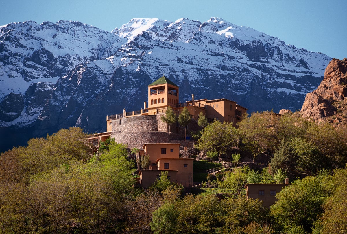old fort, now a hotel on an outcrop with snowy mountains behind