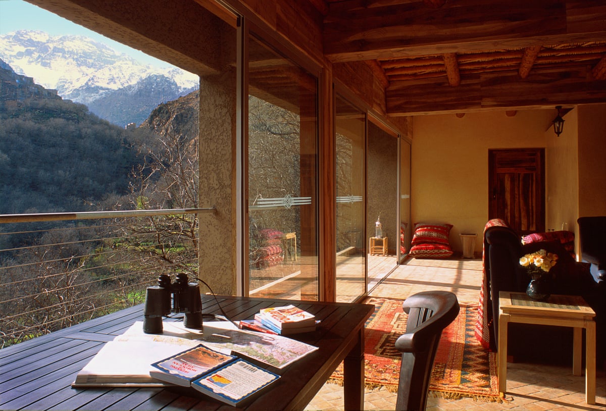 A room with large windows looking out to mountains and valley.