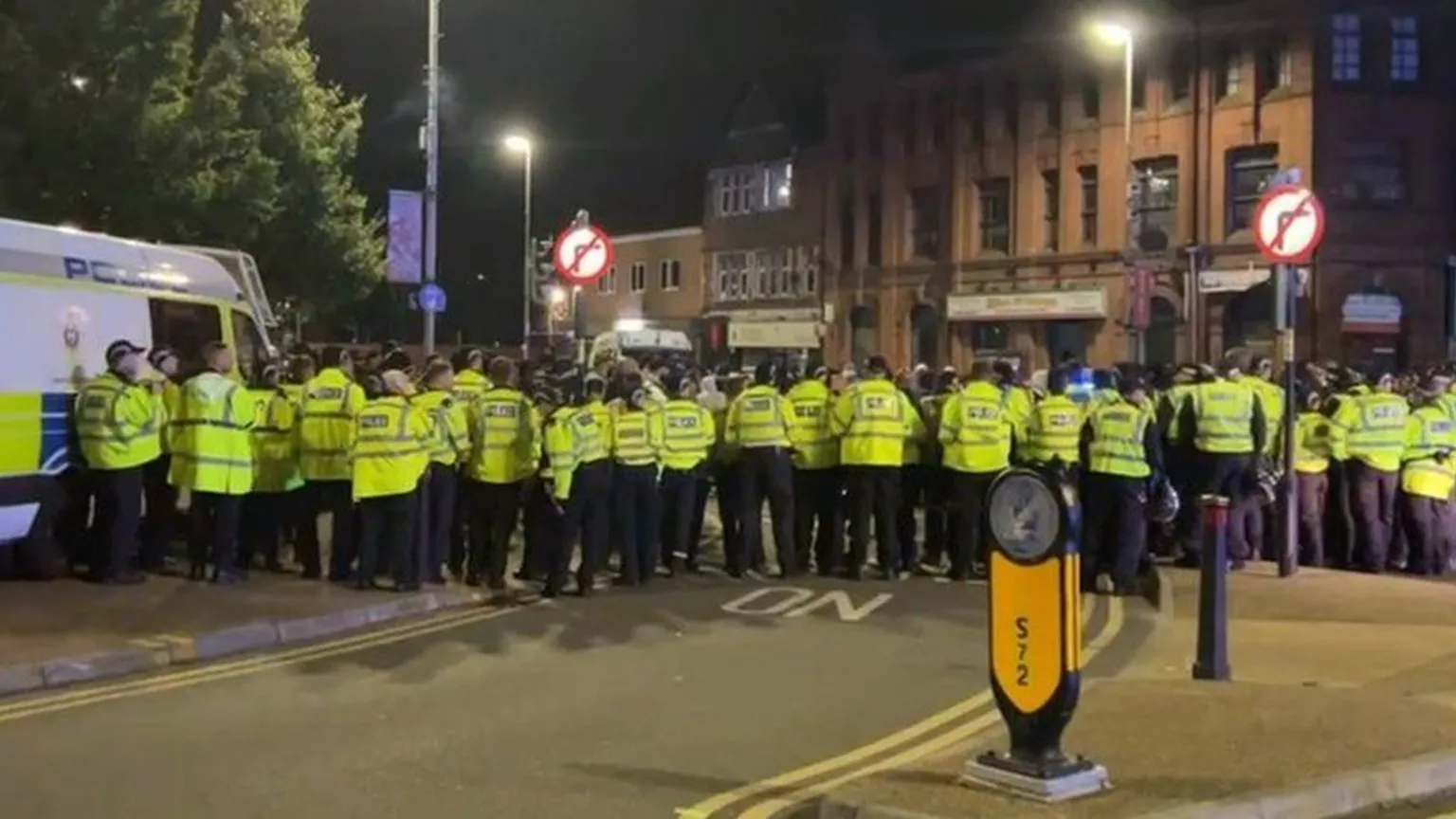 Police and protesters in east Leicester at night