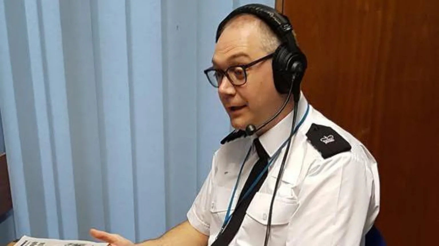 Leicestershire Police A seated police officer wearing a headset