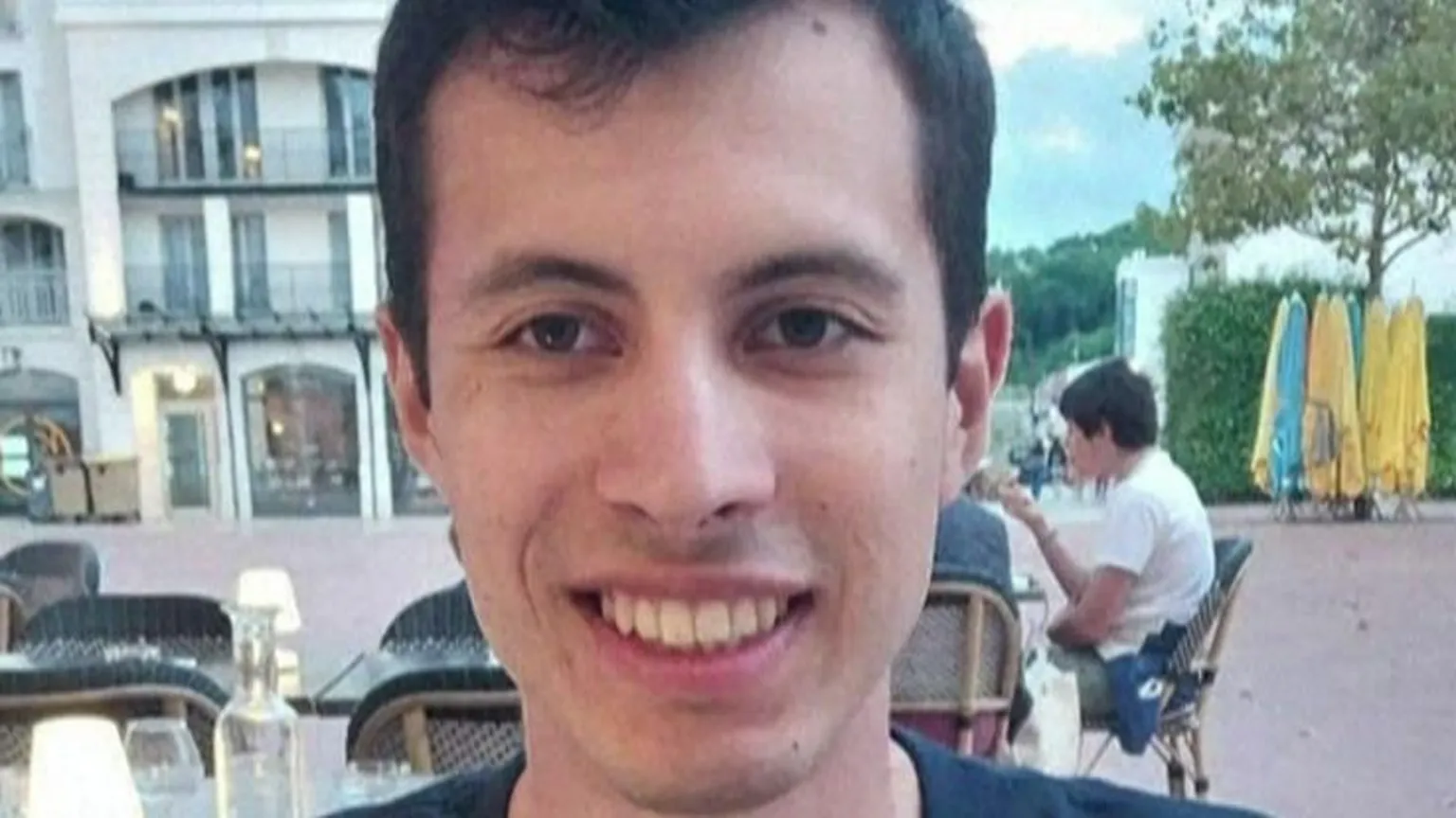 AFP A young man called Quentin Deranque sits outside