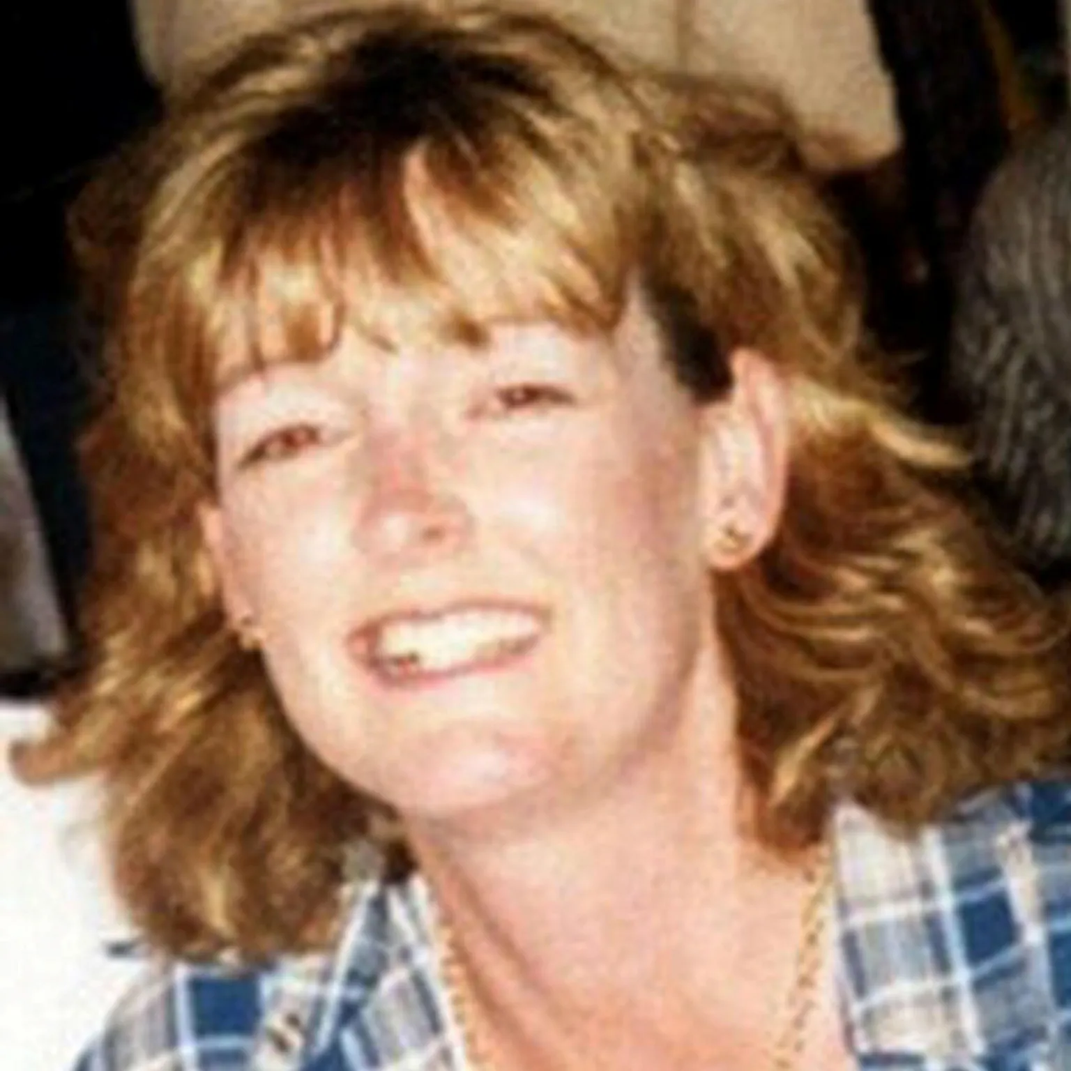 Arlene Fraser smiling for the cvamera, wearing a blue checked shirt.