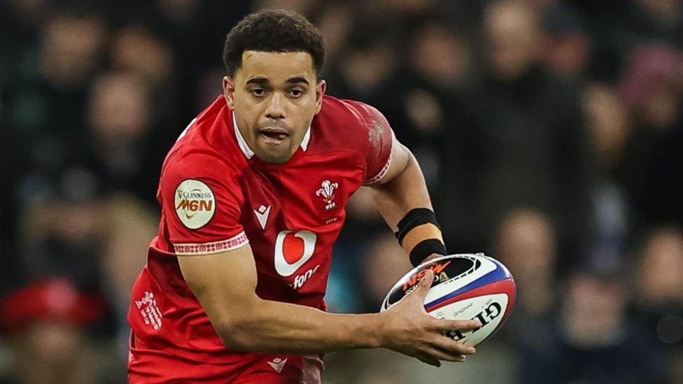 Ben Thomas carries the ball for Wales against England