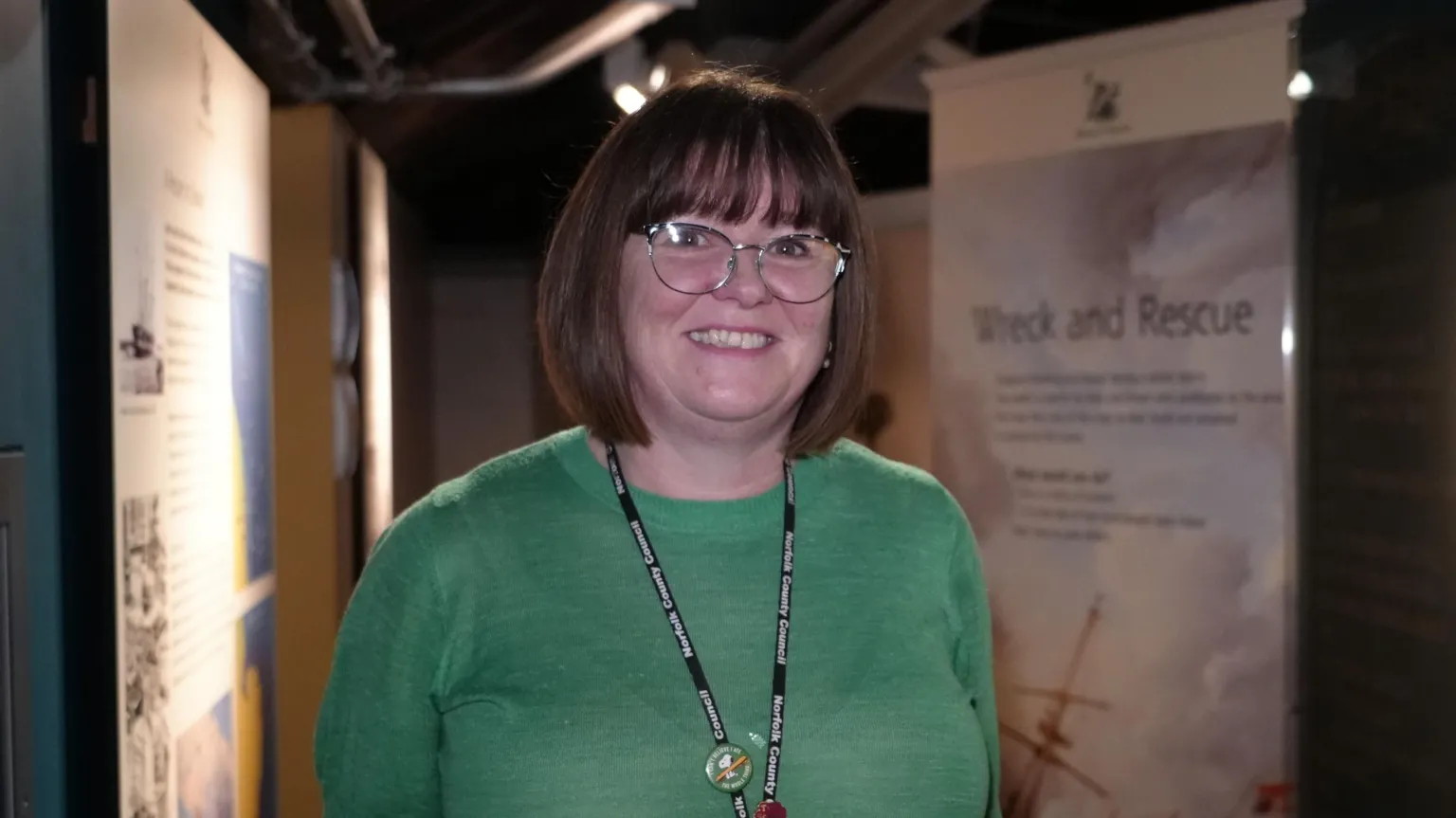Shaun Whitmore/BBC Natalie Fairweather stands in the museum. The walls have information about shipwrecks and rescues.