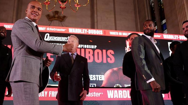 Fabio Wardley smiles as he holds out of fist to Daniel Dubois who has his back turned