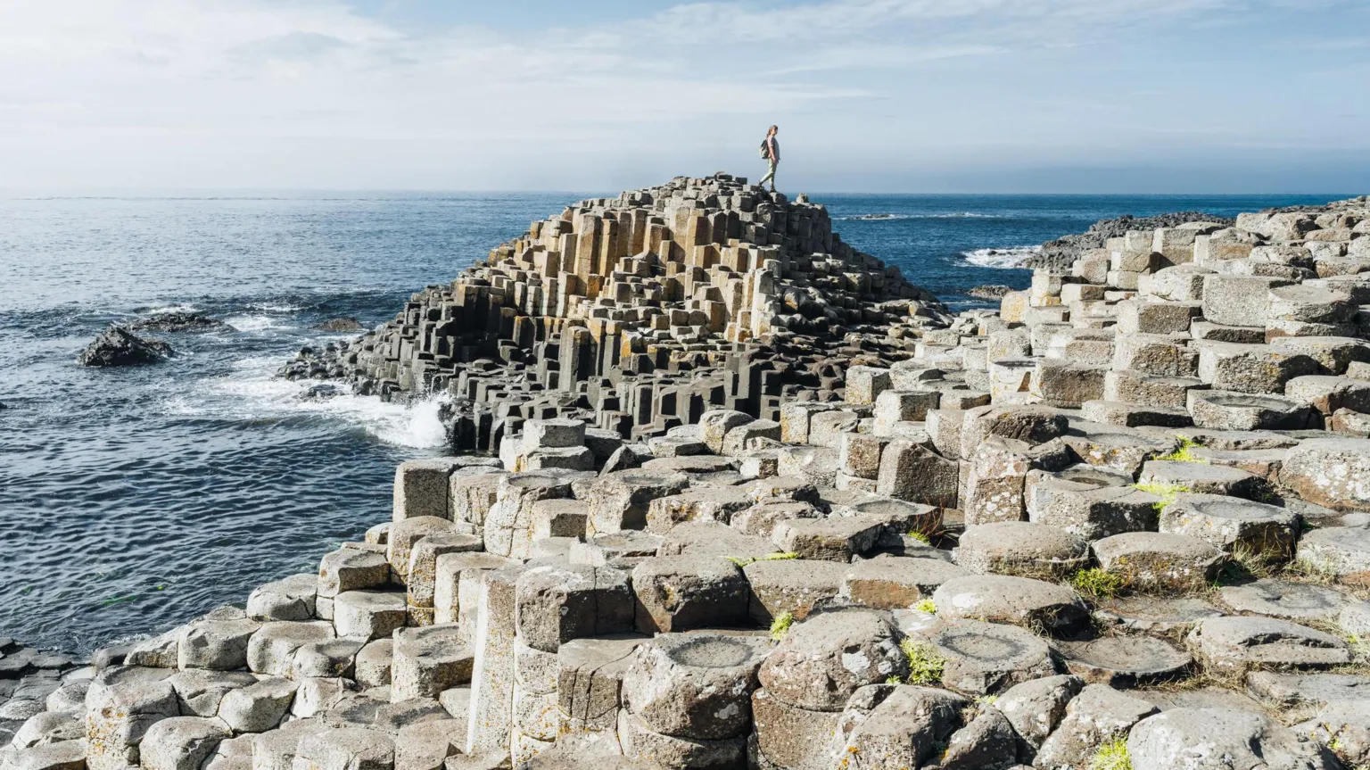  A stock image of the Giant's Causeway on Northern Ireland's north coast. It is lots of hexagonal rocks placed together beside the sea front.