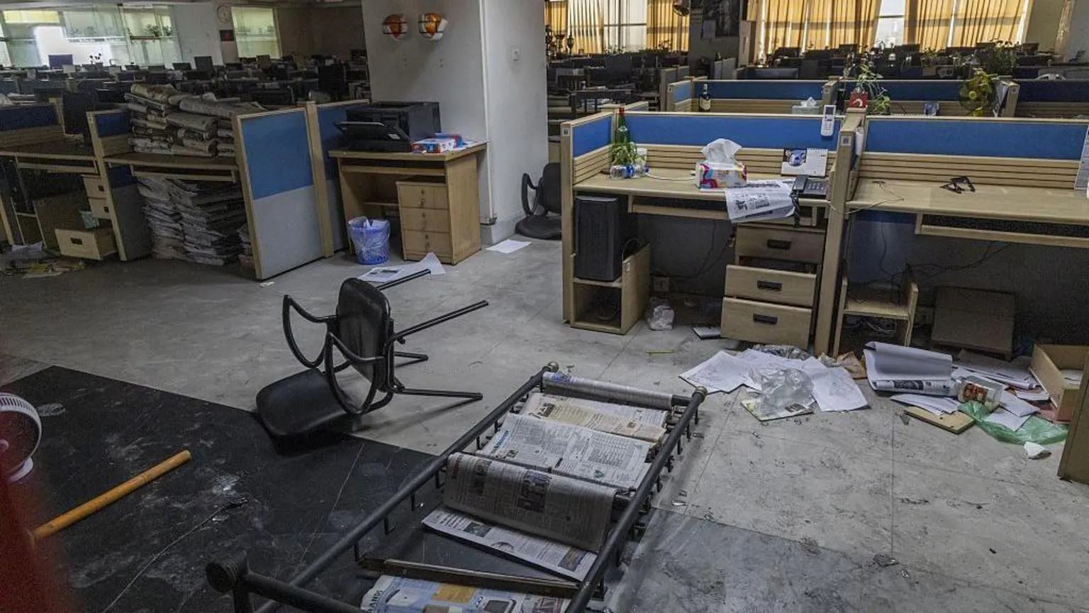 Anadolu via Newspapers strewn across the floor, chairs overturned in the wrecked Daily Star newsroom after the attack.