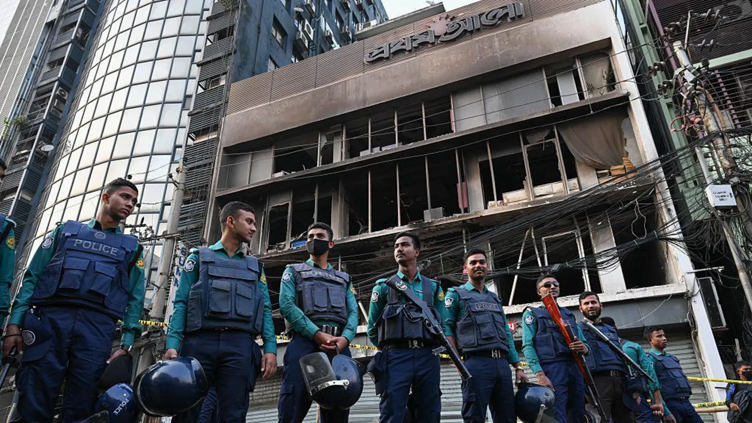 LightRocket via Police stand in front of the daily Prothom Alo building in Dhaka's Karwan Bazar after it was attacked, vandalised, and set on fire. 