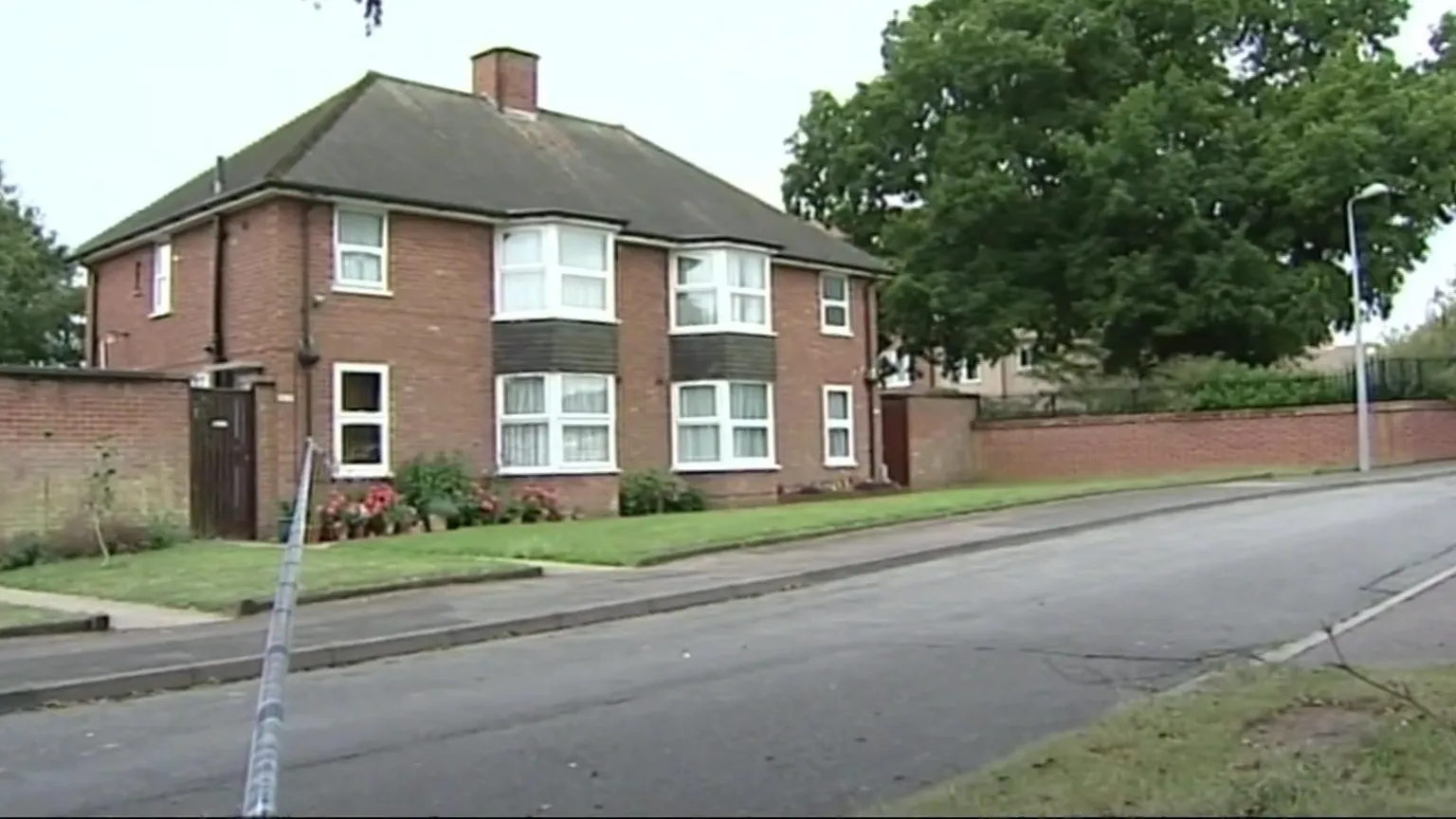 A property in Limerick Close, Ipswich. There are no cars on the road and police tape going across it.