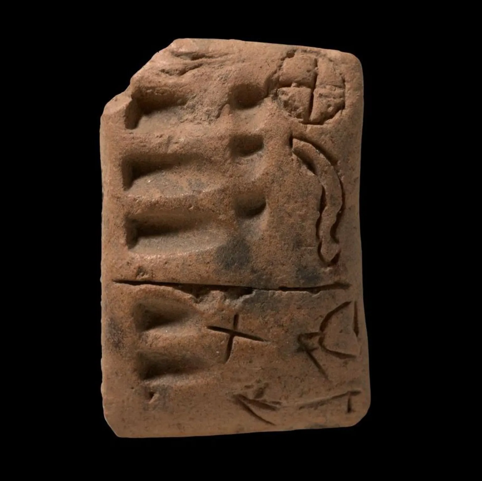 Staatliche Museen zu Berlin, Vorderasiatisches Museum / Olaf M. Tesmer A proto-cuneiform tablet from around 3350 years ago, showing numerical symbols on the left side and a variety of ideograms on the right.
