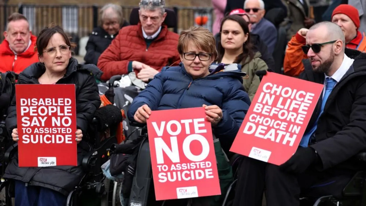 EPA Former Paralympian Baroness Tanni Grey-Thompson (C) holds a banner which reads