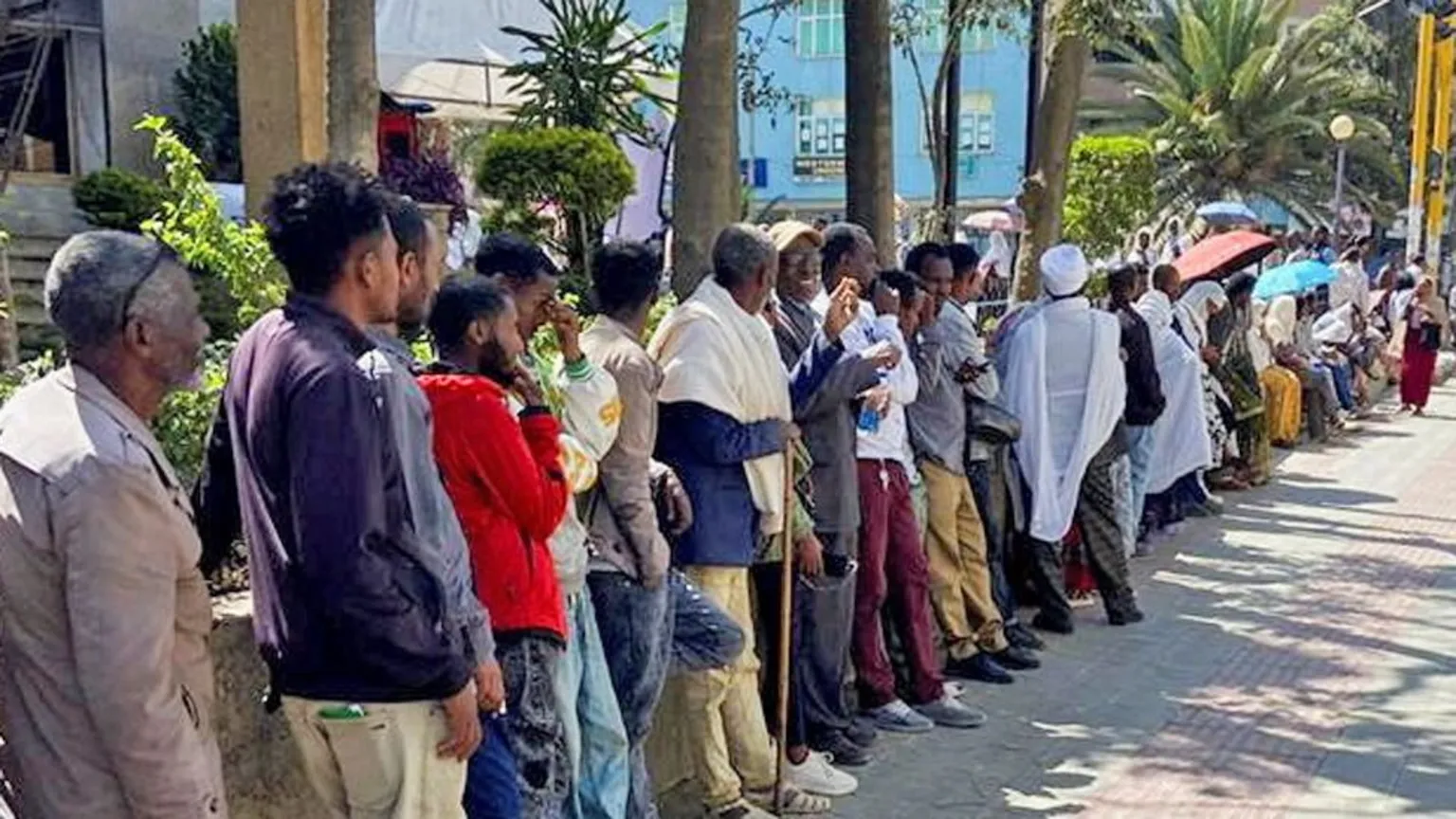  A long line of men and women queuing along a street in Mekelle for the bank - January 2026