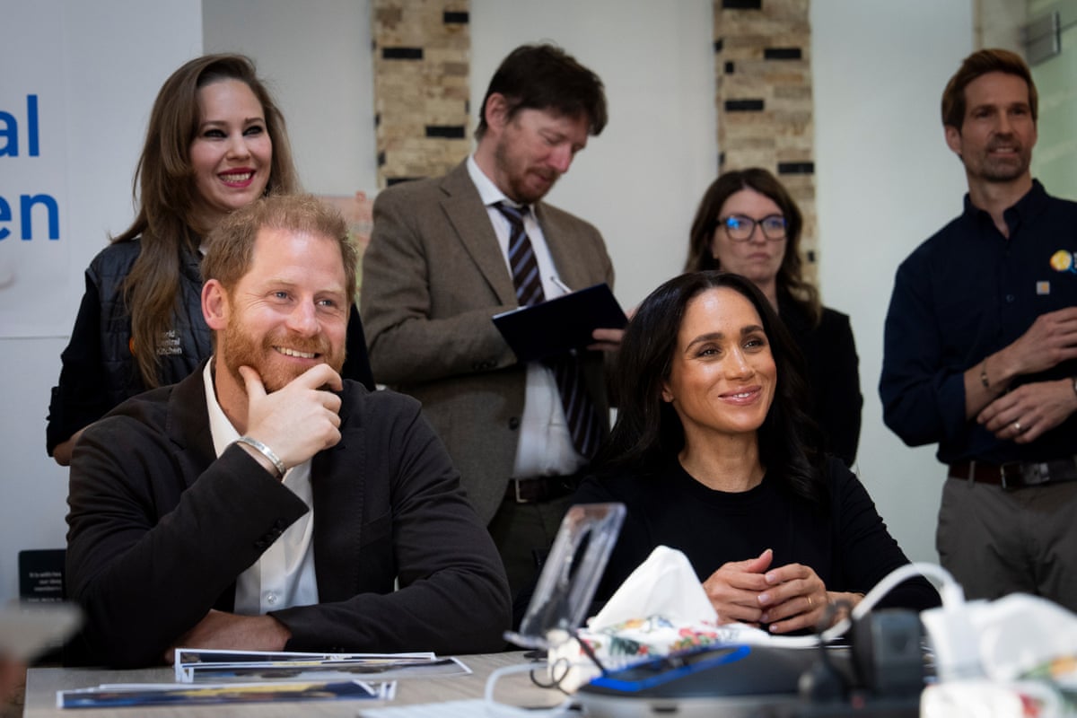 Harry and Meghan sat at a table speaking to WCK members.