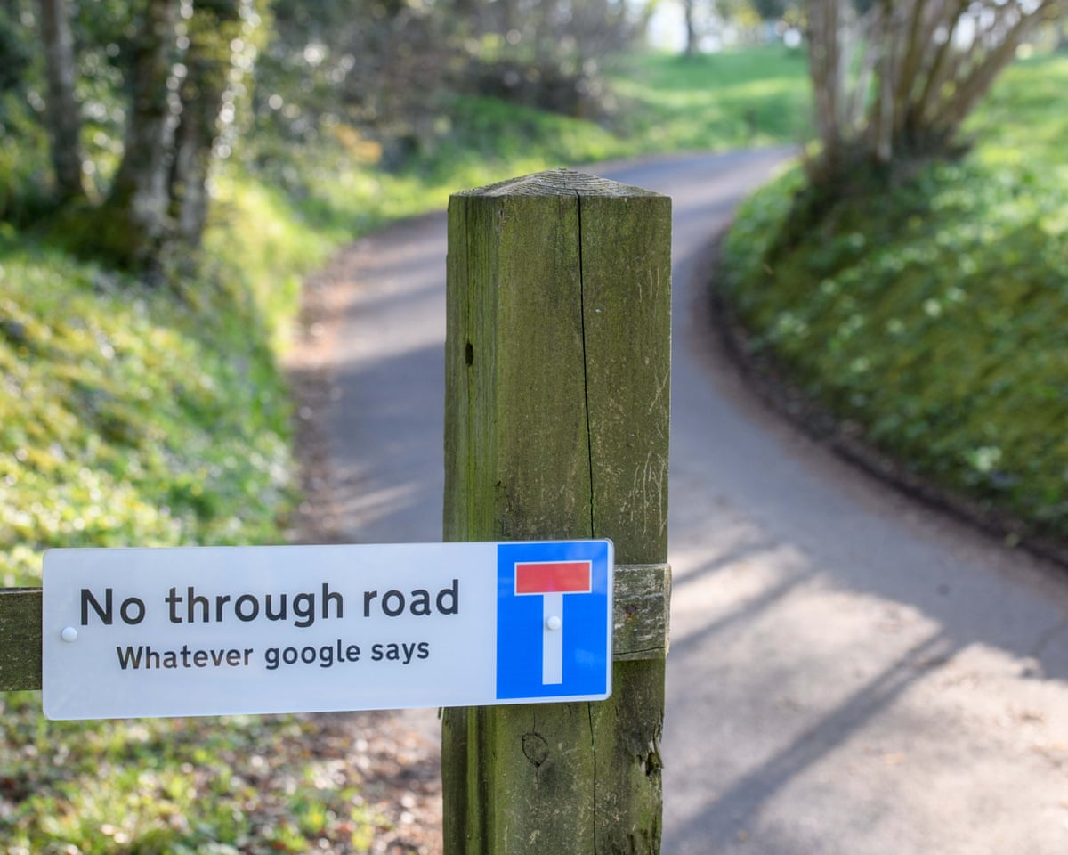 A sign reading 'No through road whatever google says' beside a country road