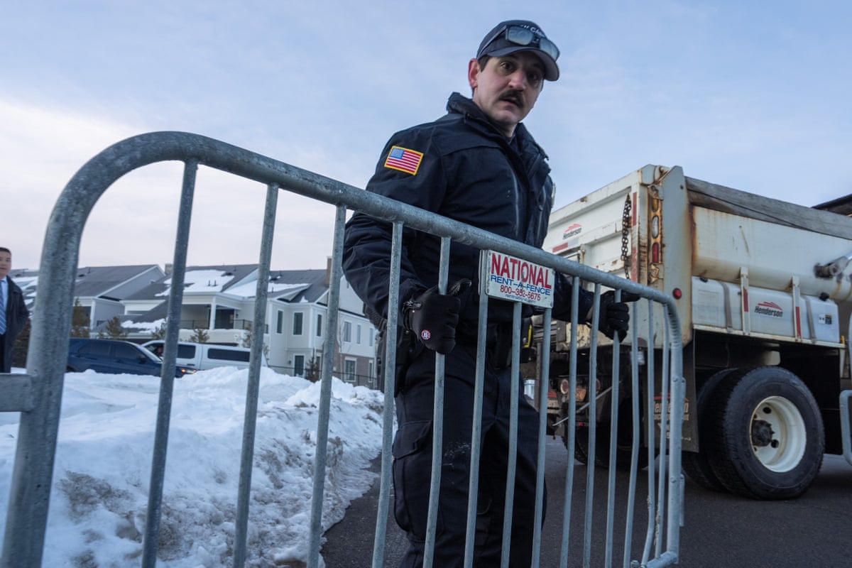 a man holds a police barricade
