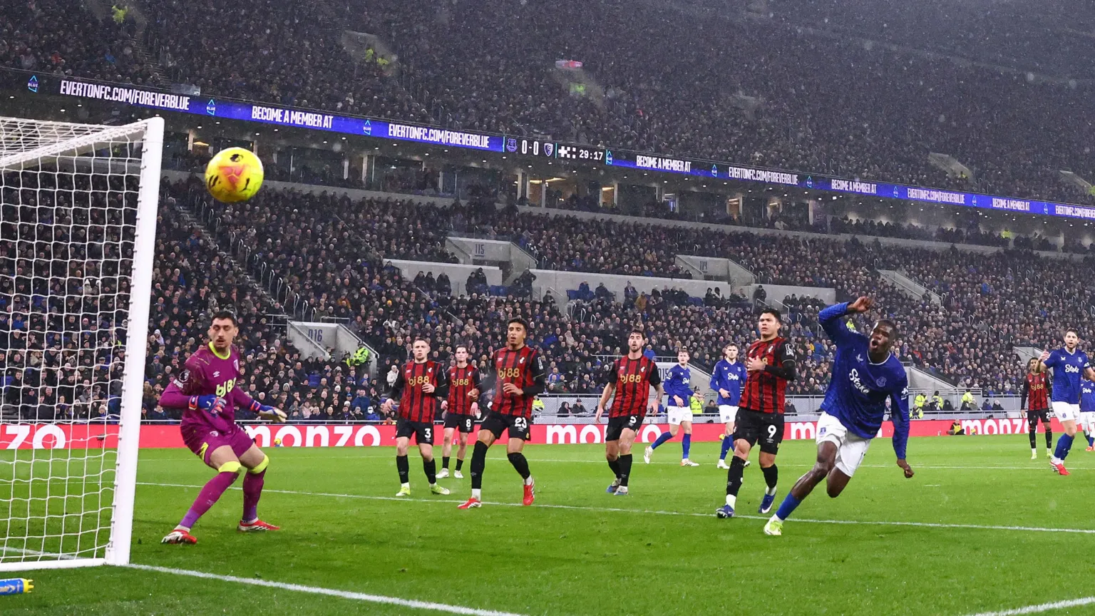 AMA via Thierno Barry of Everton wheels away from goal as the ball shoots just wide of the goalpost. Bournemouth players look on.