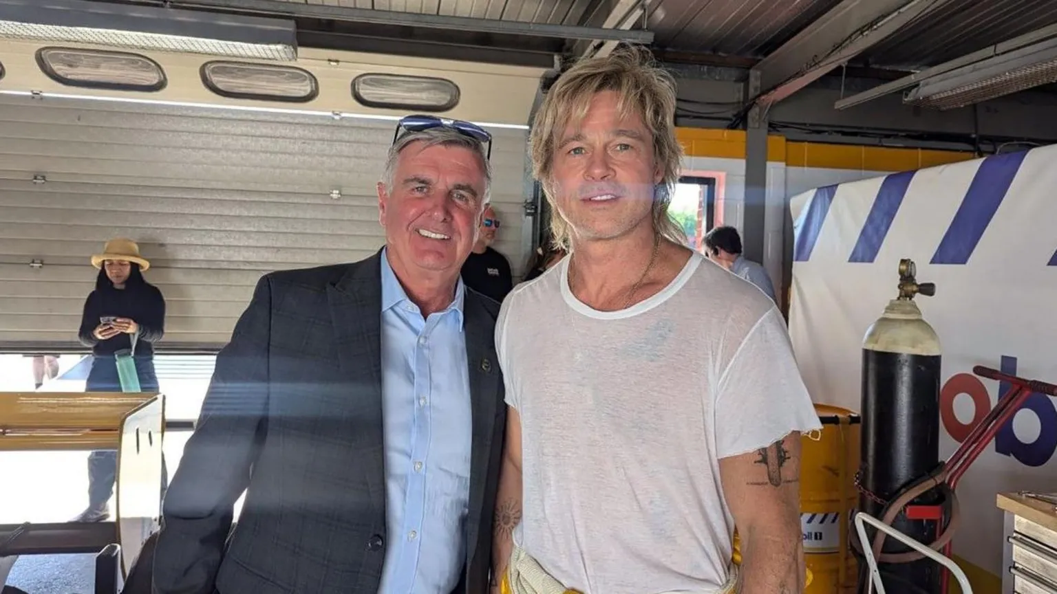 Martin Donnelly Martin Donnelly (left) a man with grey hair and glasses on his head, wearing a dark jacket and blue shirt. Alongside him is Brad Pitt, a man with blond hair, wearing a white T-shirt.
