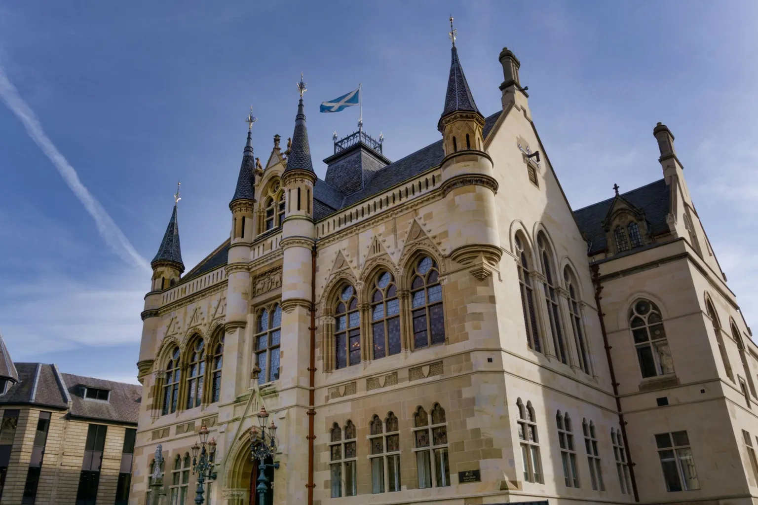  Inverness Town House is a sandstone building with ornate windows and carvings in its exterior walls and fairytale castle-like turrets.