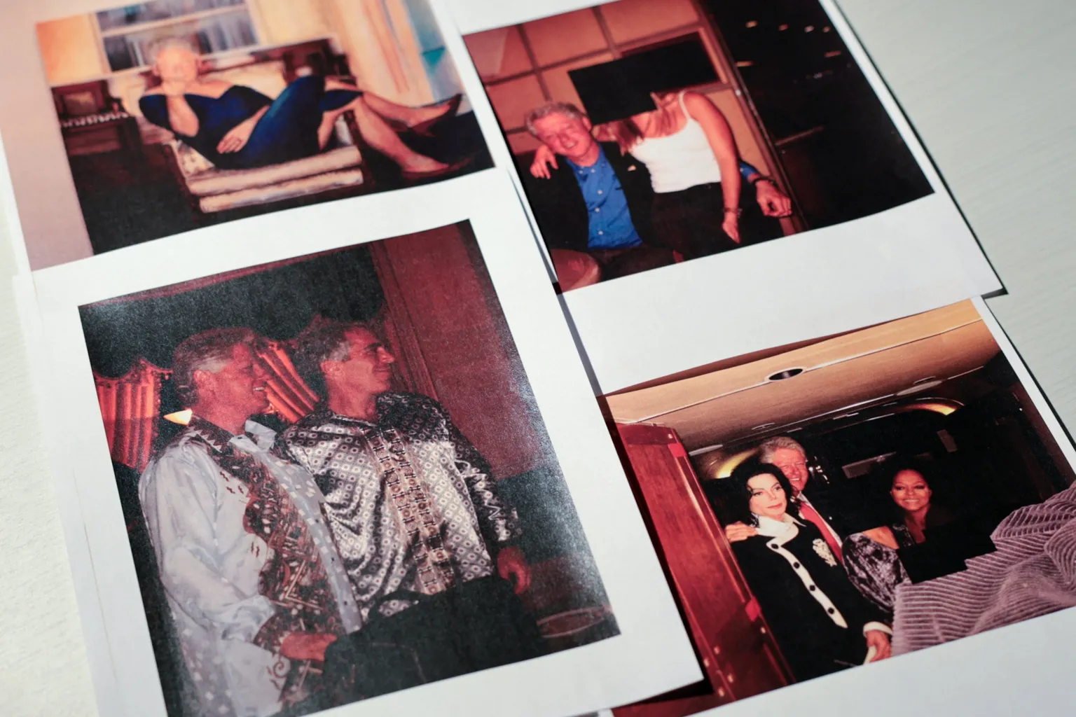  Photos of Bill Clinton released in the Epstein files show Clinton with Epstein, Clinton with Michael Jackson, Clinton with a young woman on his lap whose face has been redacted, and a satirical painting Epstein had of Clinton
