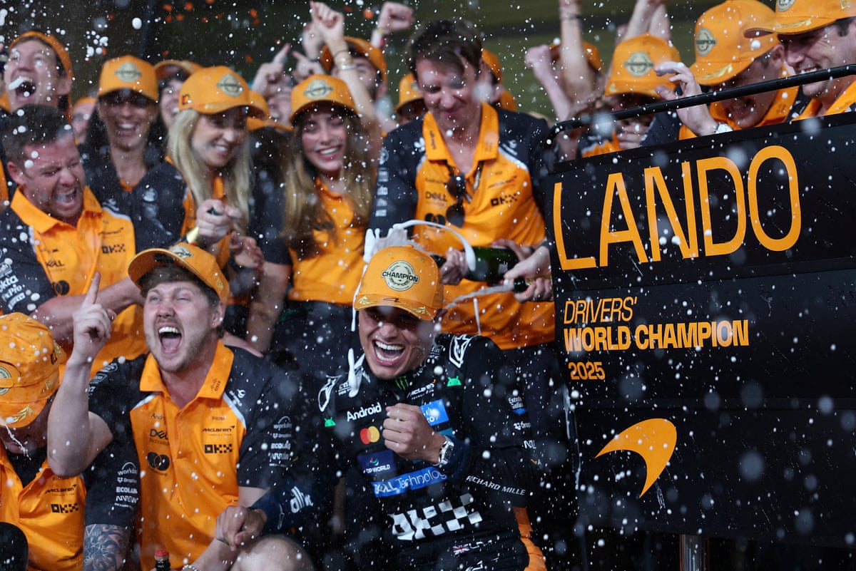 Lando Norris celebrates with the McLaren team