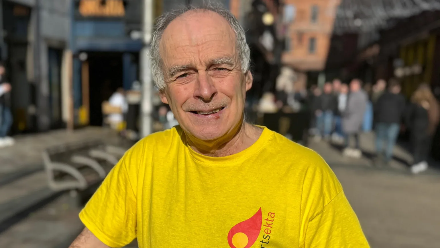 A man with grey hair smiling 