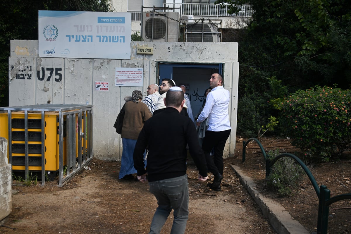 Israelis enter an underground shelter