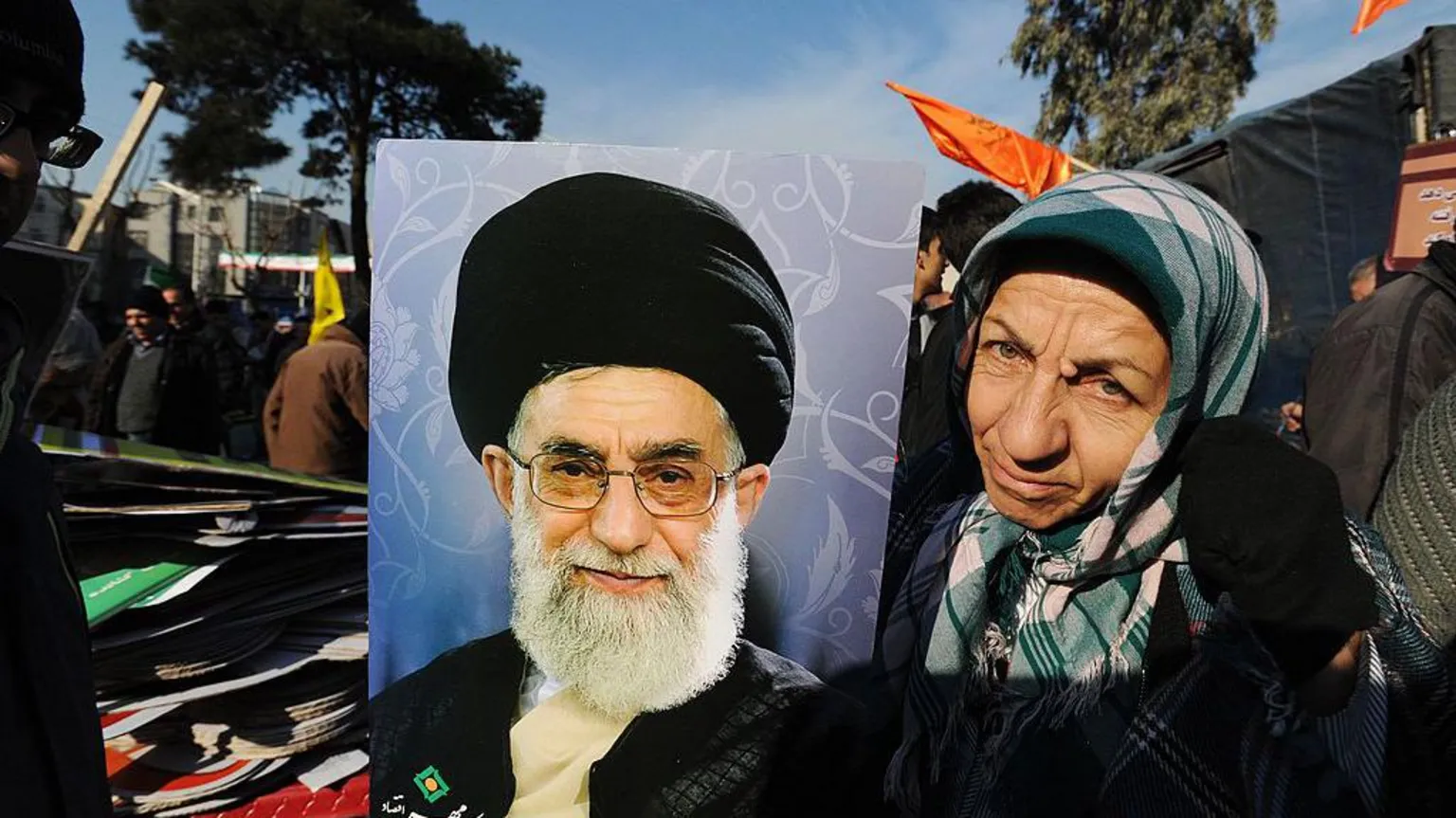  An Iranian woman poses with a portrait of Supreme Leader Ayatollah Ali Khamenei 