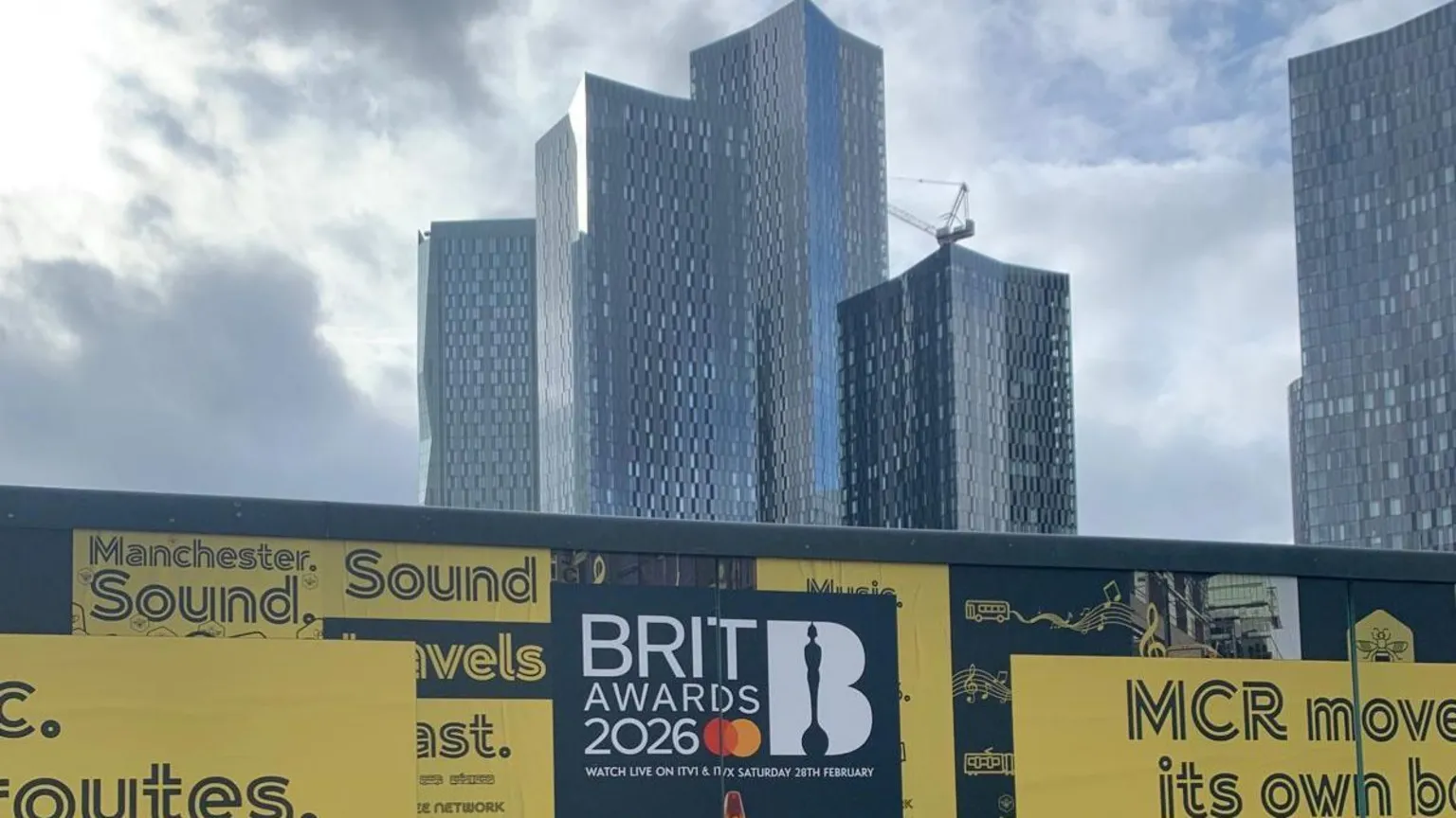 A Brit Awards poster in front of the Manchester city skyline