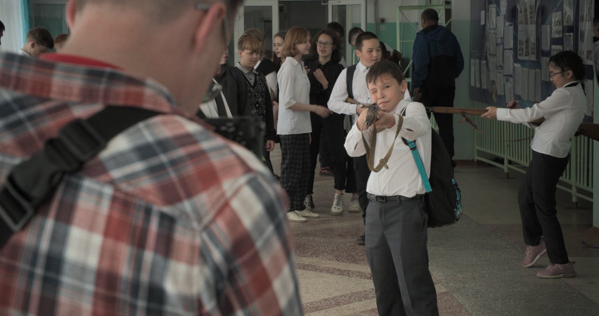 A group of schoolchildren holding guns