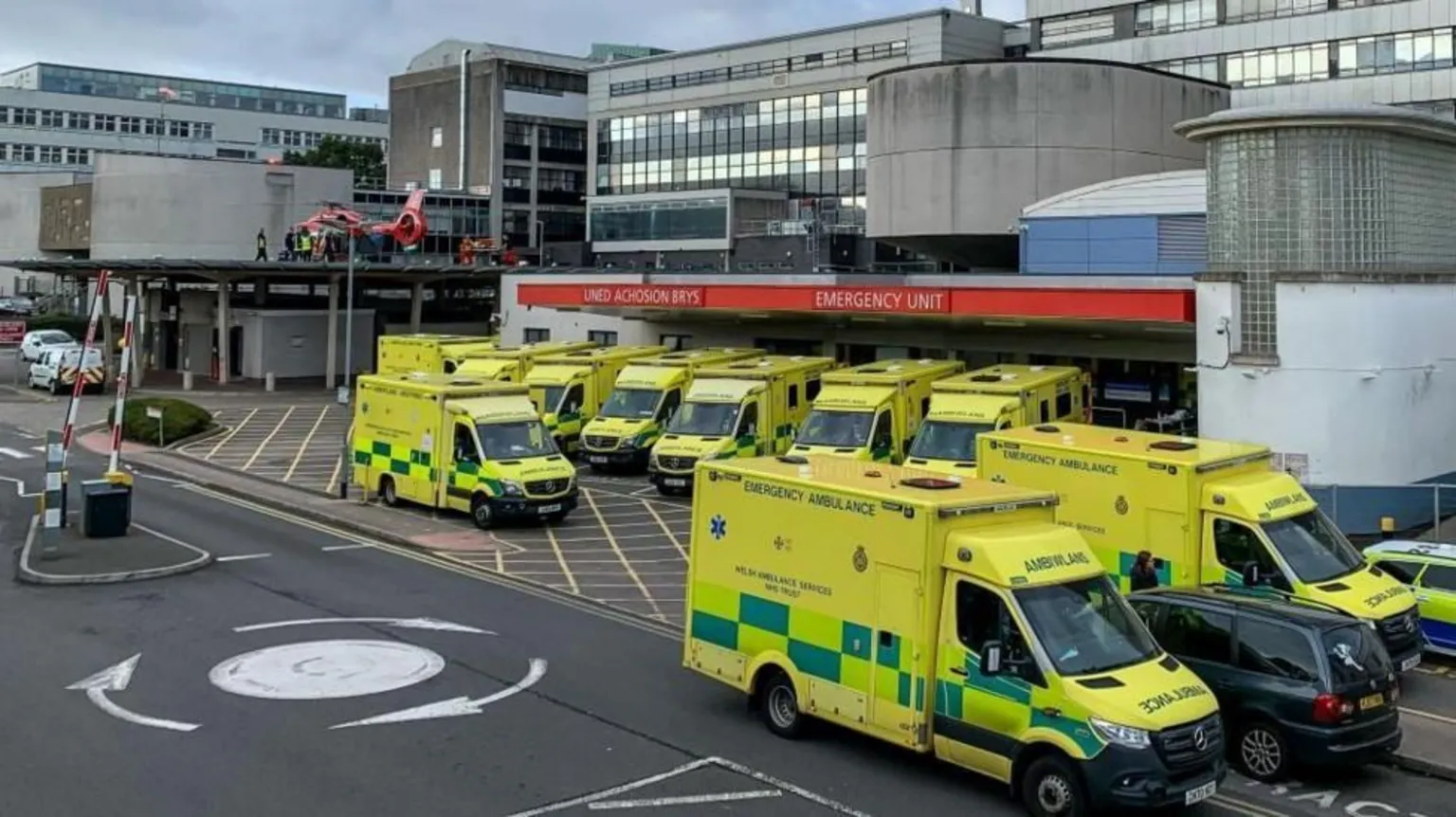 A view of the Accident and Emergency Unit at the University Hospital Wales showing ambulances parked outside the Emergency unit together with one of the Welsh Air Ambulances on a rooftop helipad.