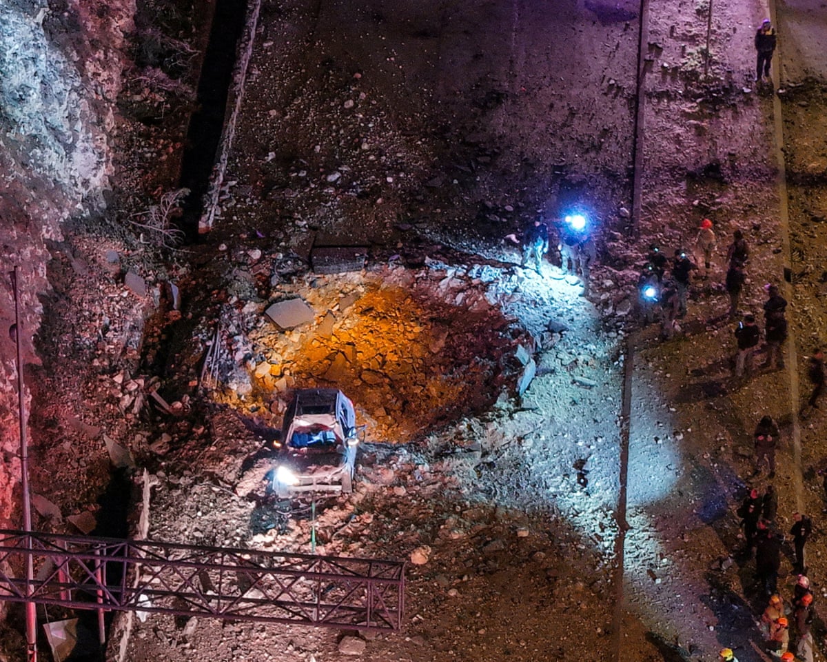 A drone view of Israeli emergency responders working at the scene of an Iranian missile strike on a road in Jerusalem on Sunday