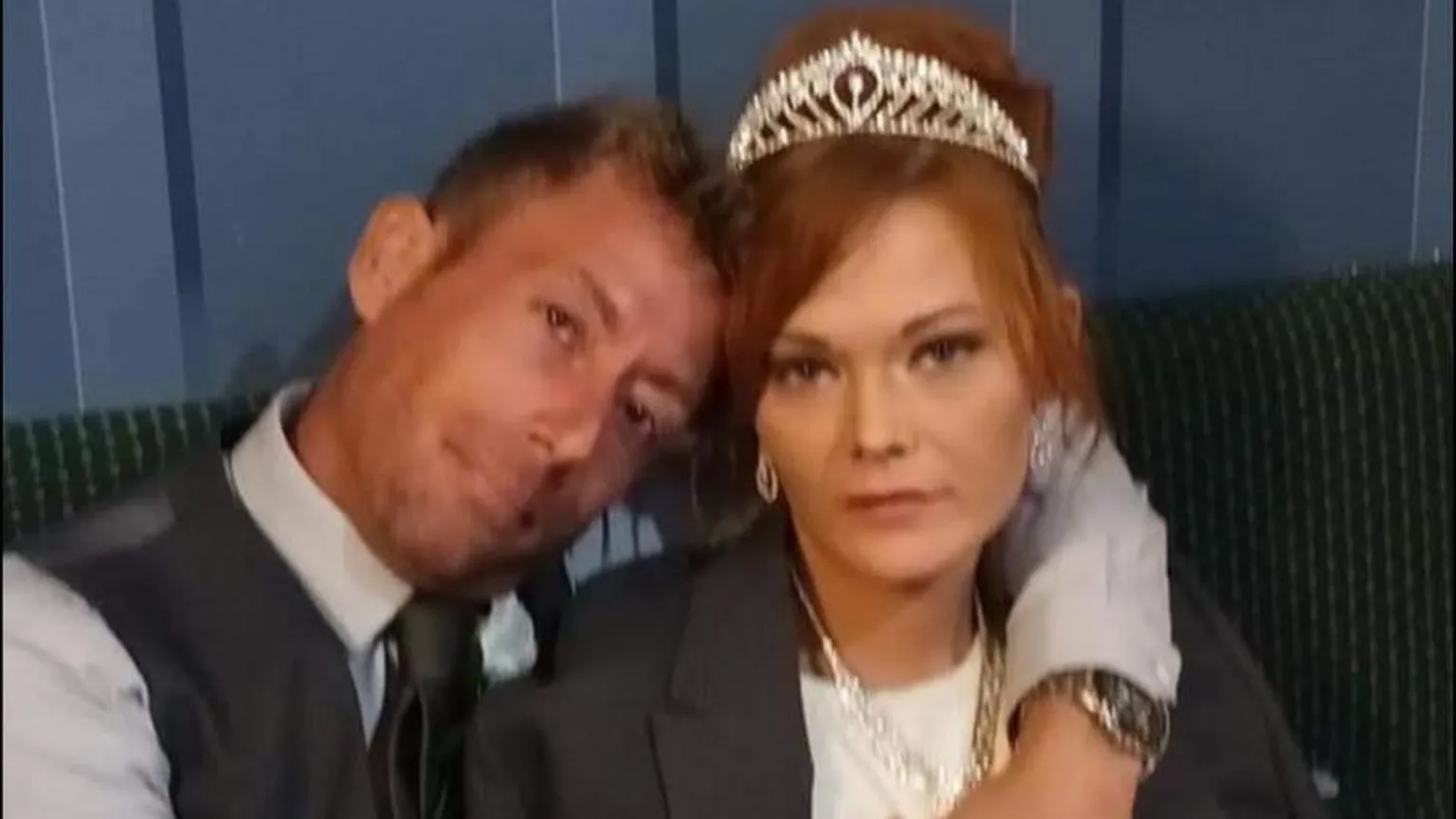 Facebook A man and woman on their wedding day look at the camera