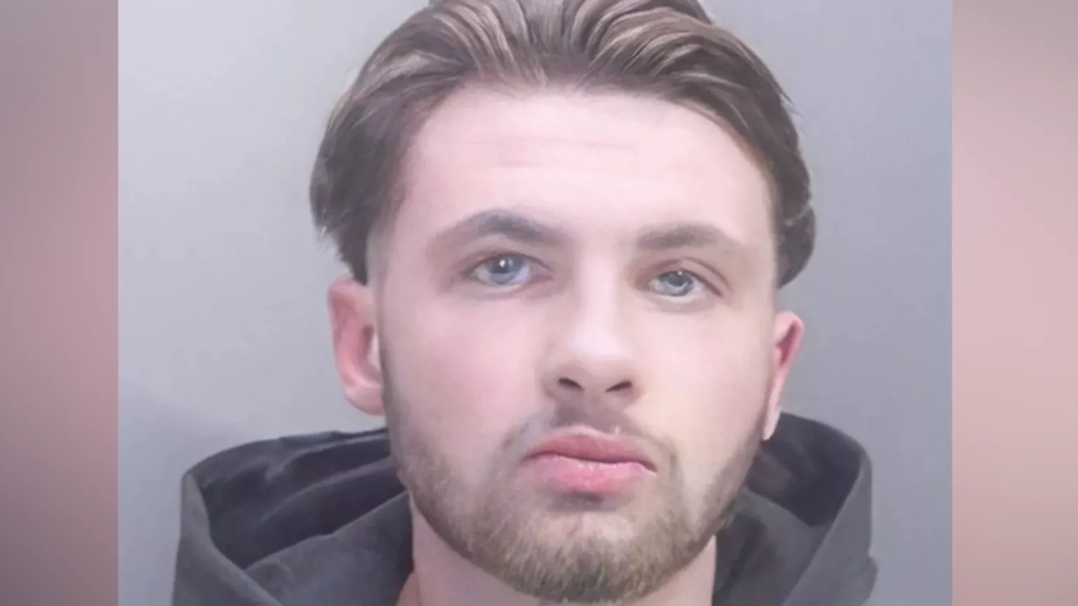 Cambridgeshire Police Police mugshot of Chas Corrigan. He is wearing a dark hoodie and has brown hair swept back and a beard.