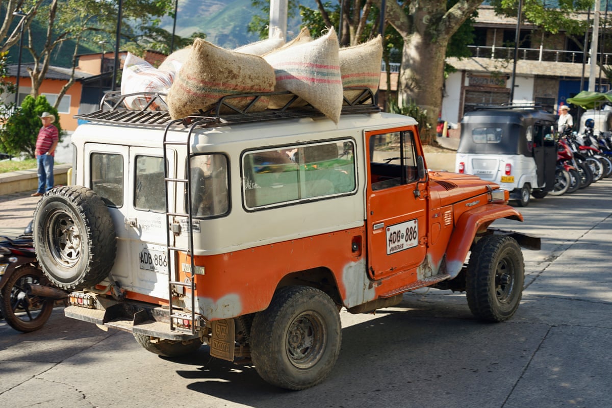 Sacks of coffee being transported on the roof of an ageing Toyota 4x4 in Betulia, Antioquia, Colombia.