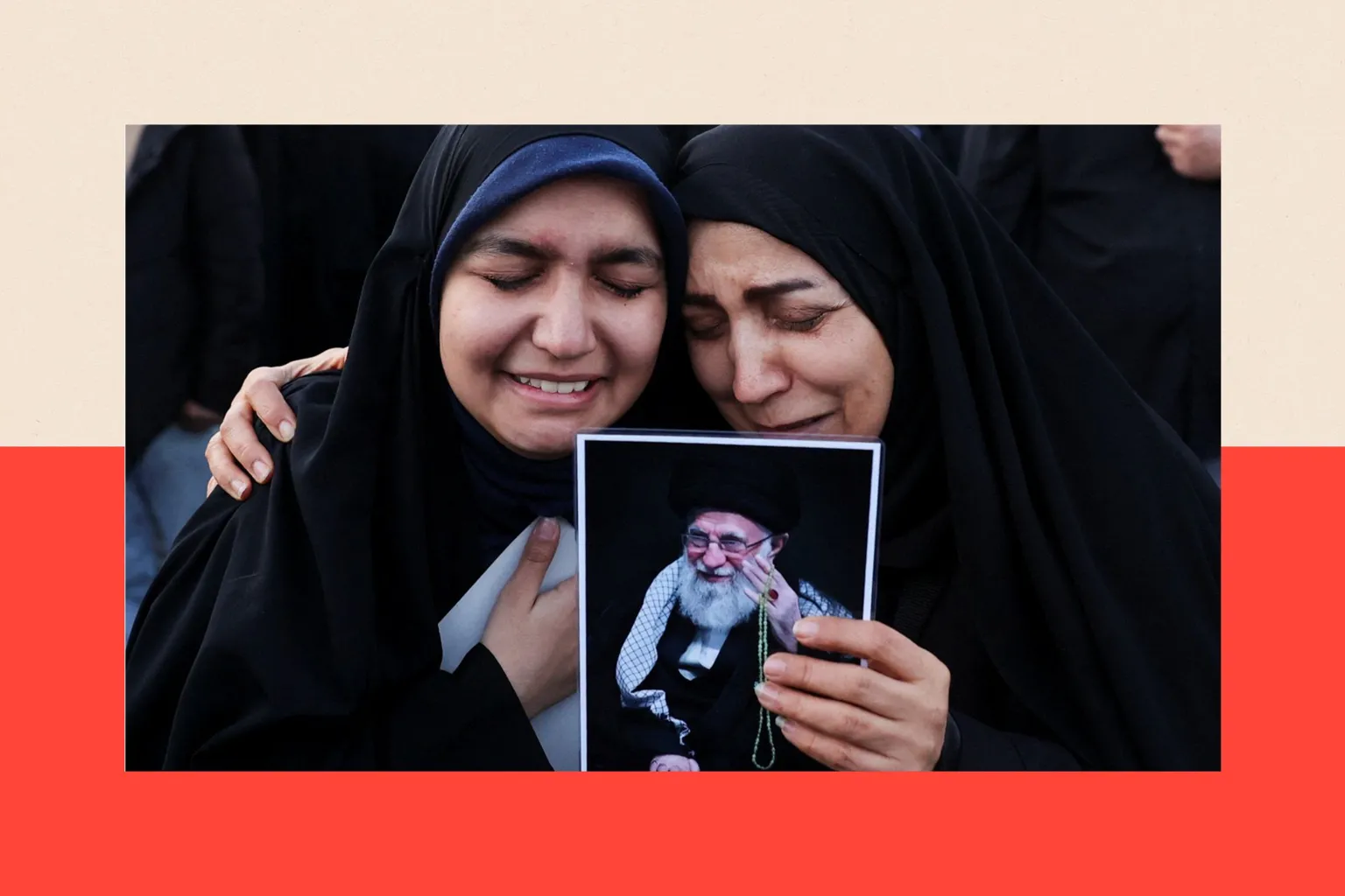  Two women clutch each other and hold an image of Khamenei after Iran's Supreme Leader was announced as having been killed 