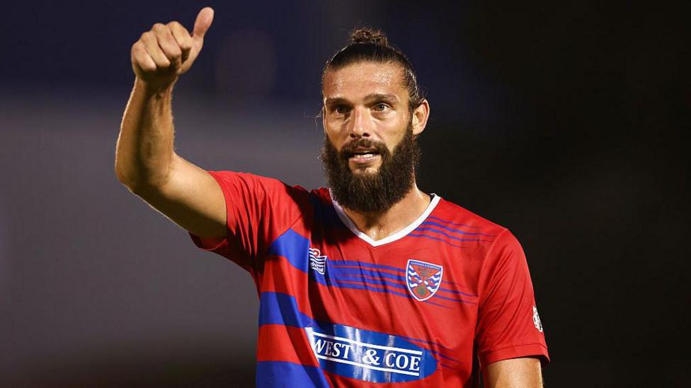 Andy Carroll holds a thumbs up signal