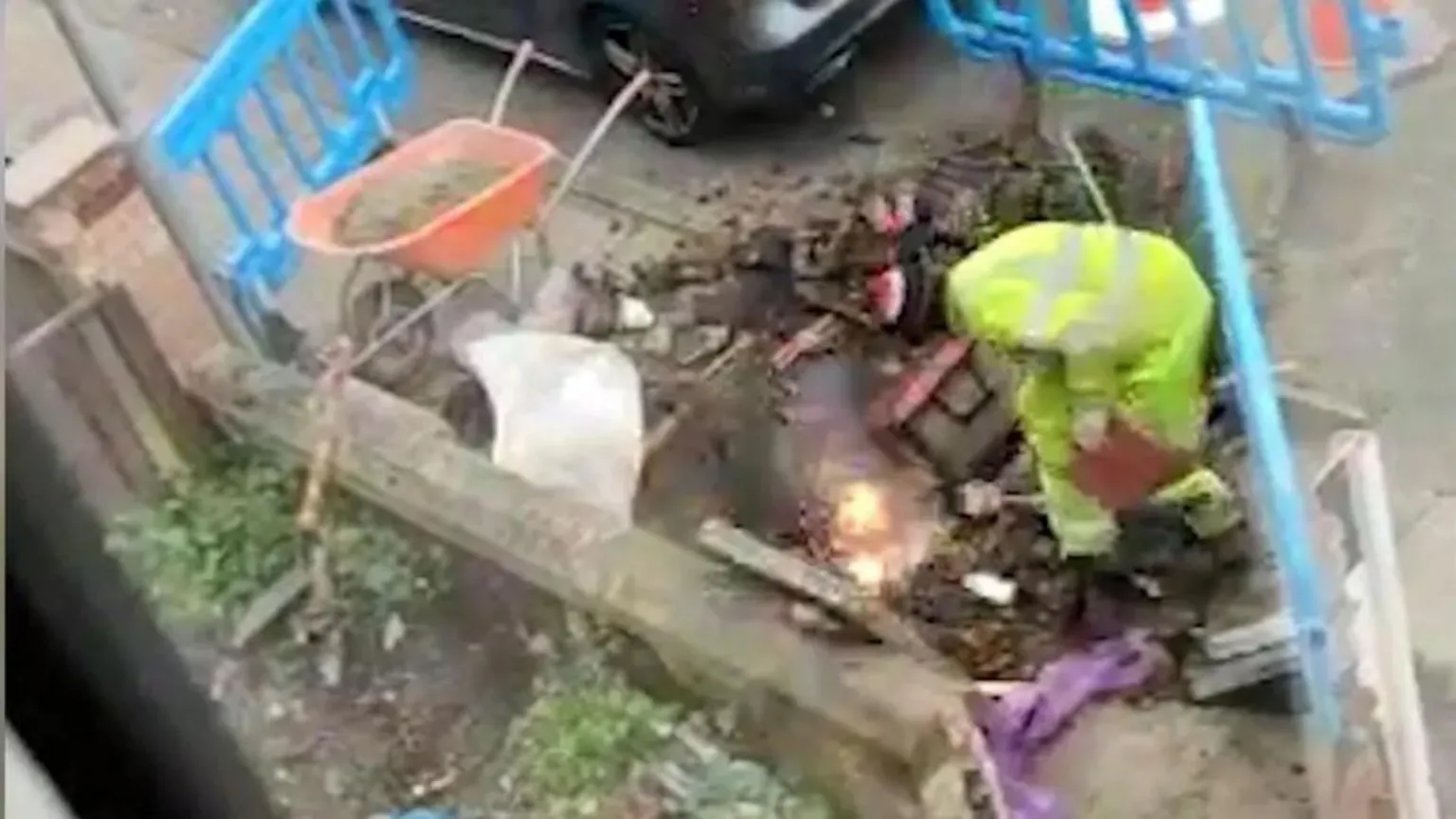 North West Organised Regional Crime Unit Fake worker in high vis crouches as pipes explode into flames in hole he dug up in the road