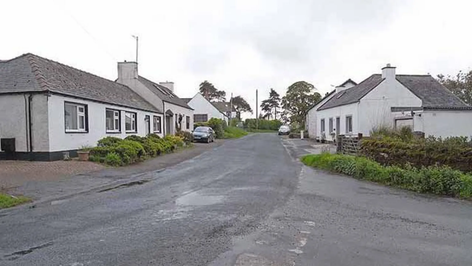 Oliver Dixon The village of Milton with houses on both sides of the road