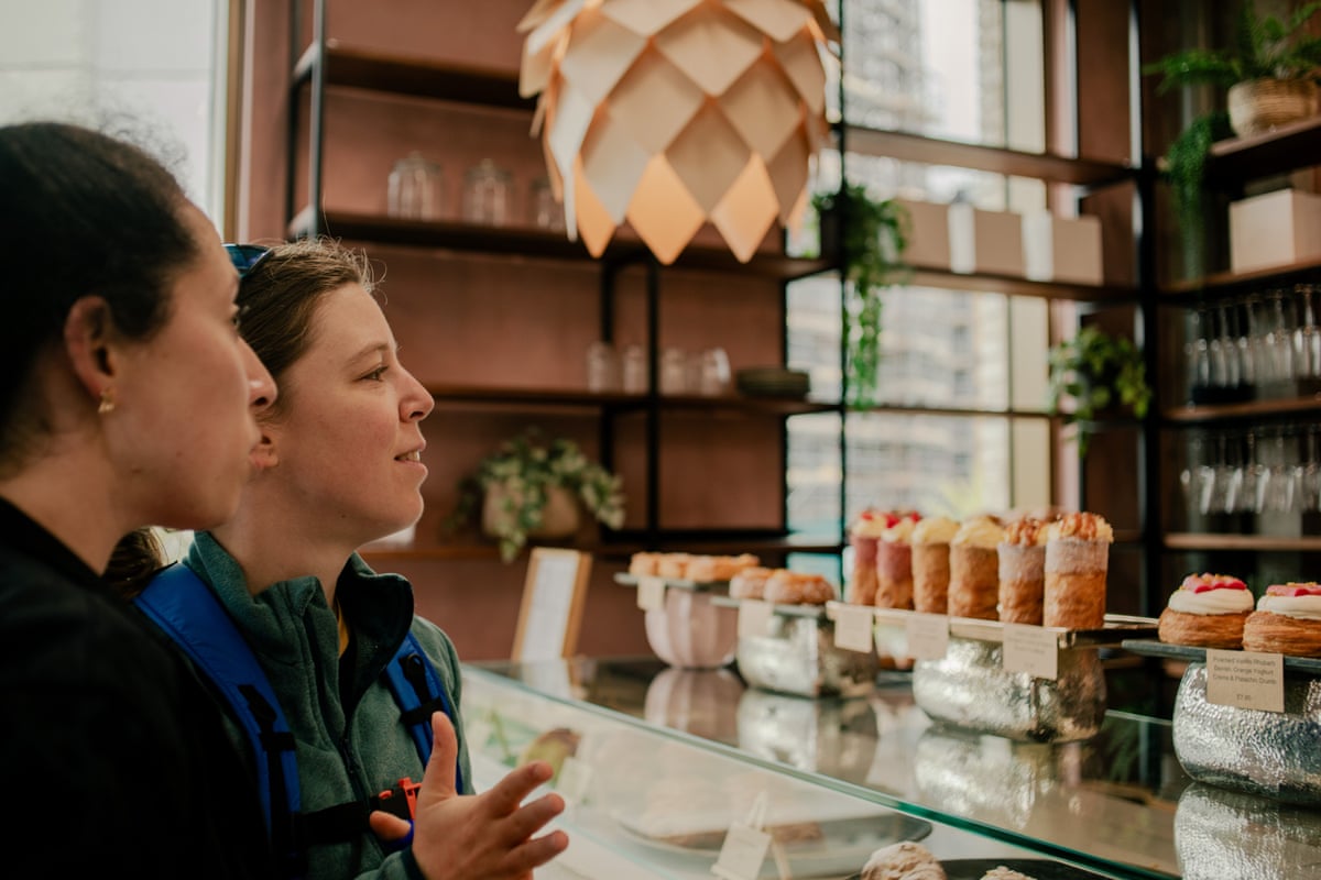 Standing at the glass counter, they cast their eyes over the baked goods