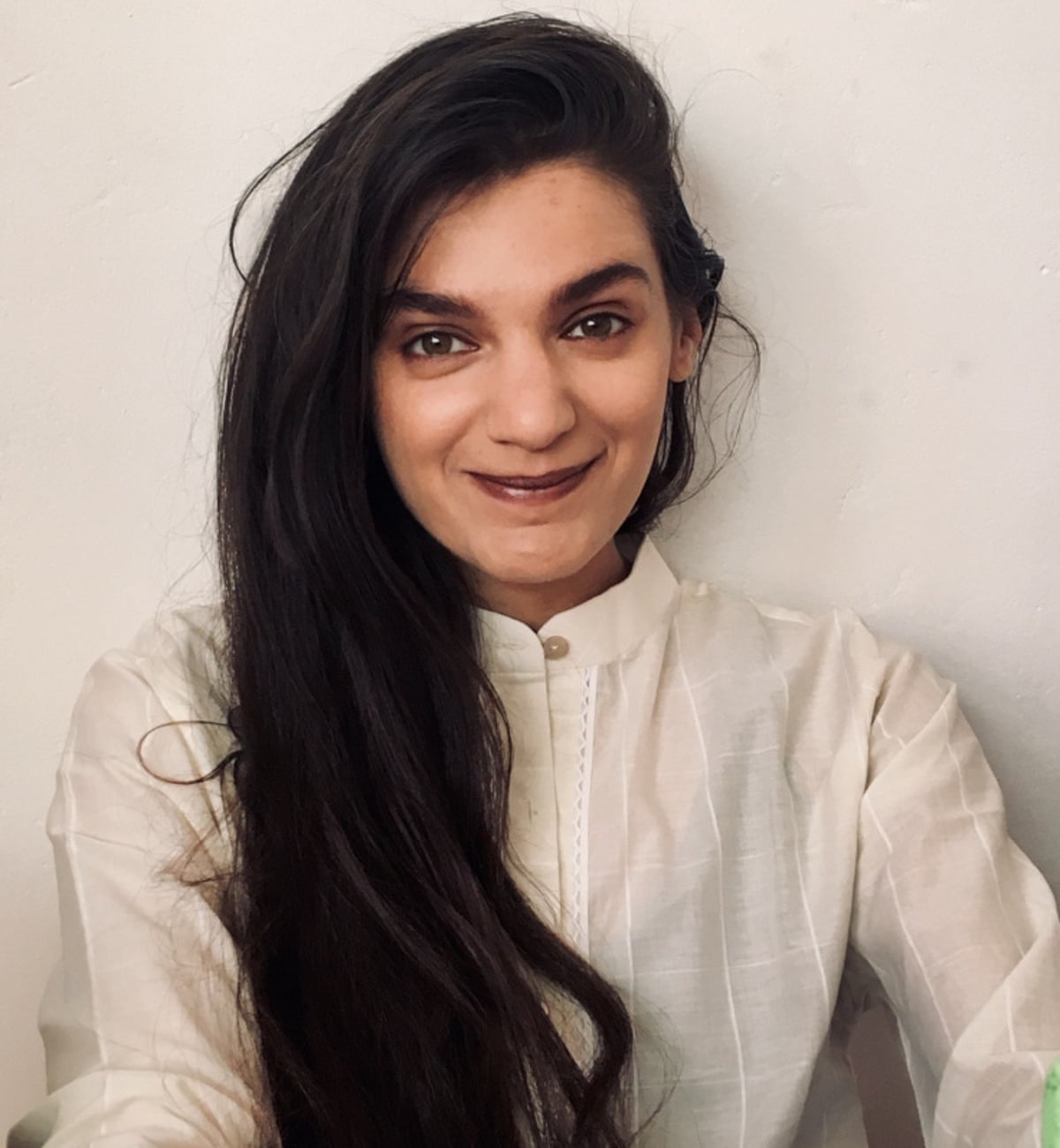 A closeup of Yasmin Begum wearing a white shirt 