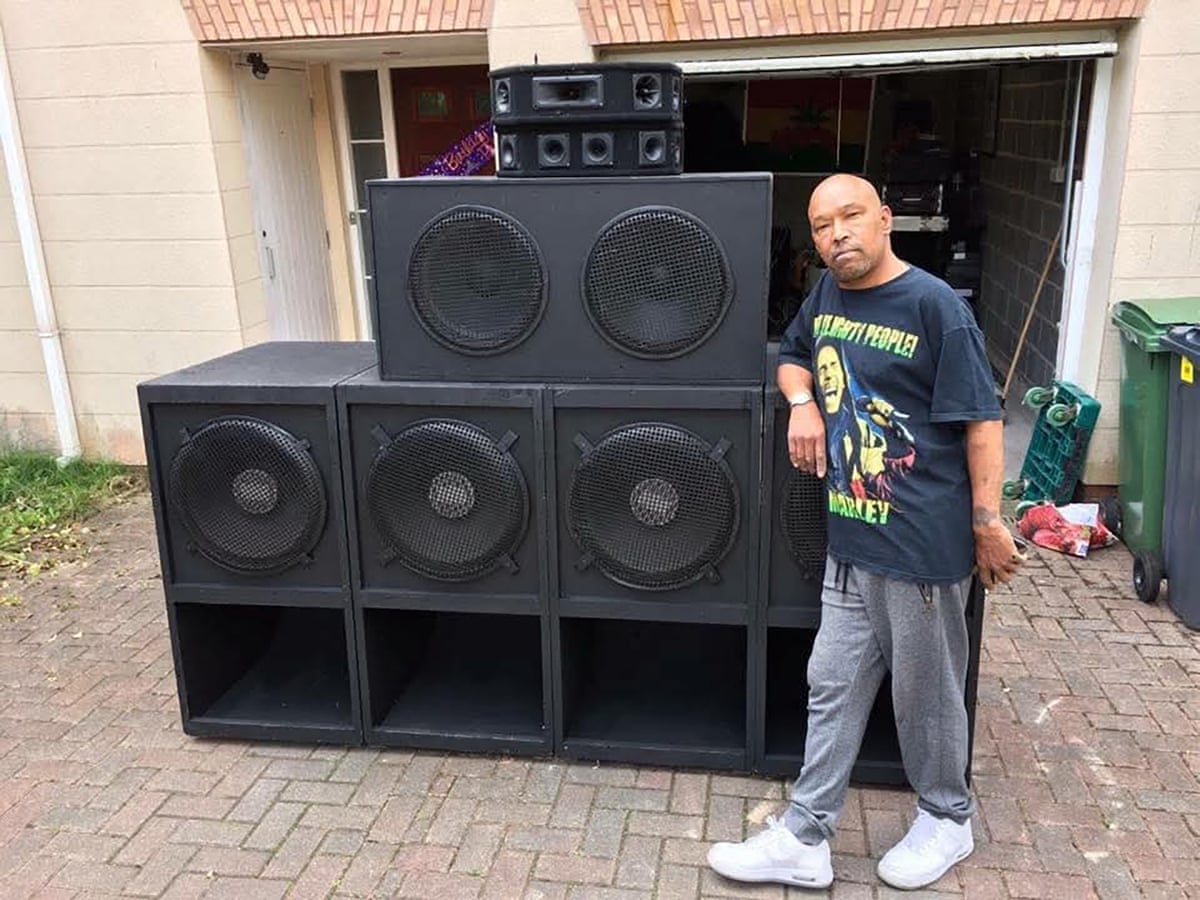 Gary Jemmett standing beside a huge sound system