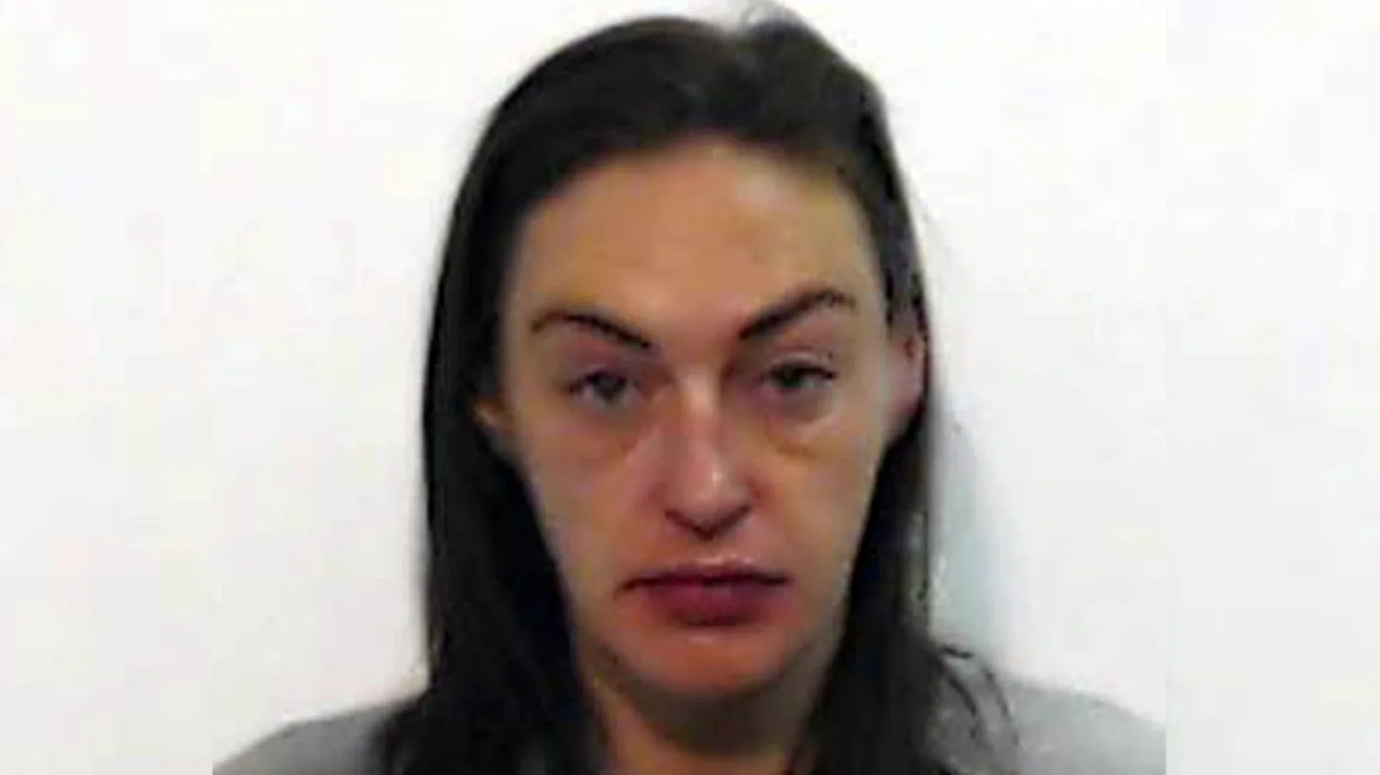 Police Scotland A police mugshot of Natasha Smith who is in her late 30s with long, brown hair