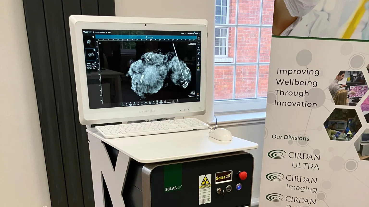 A machine with a white monitor on top of it and a poster next to it.