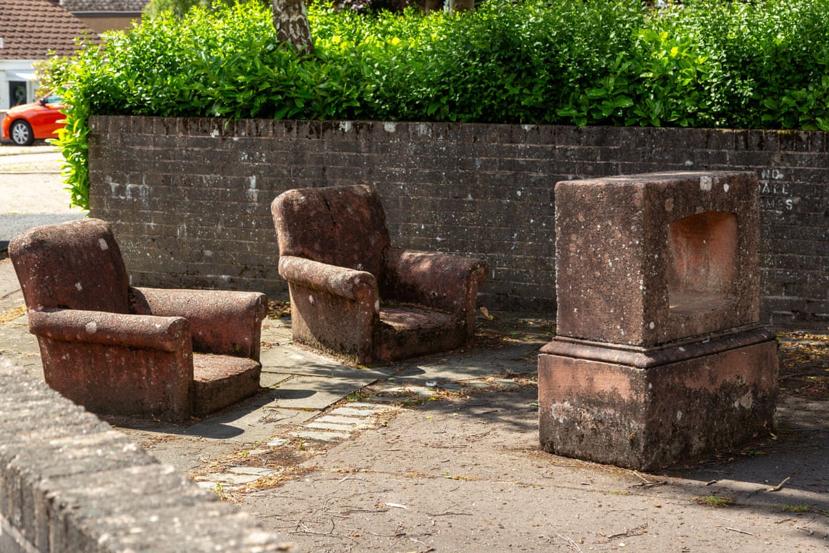Street sculpture of two armchairs in front of empty television