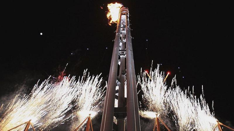 The flame is lit at the 2006 Winter Paralympics as fireworks go off