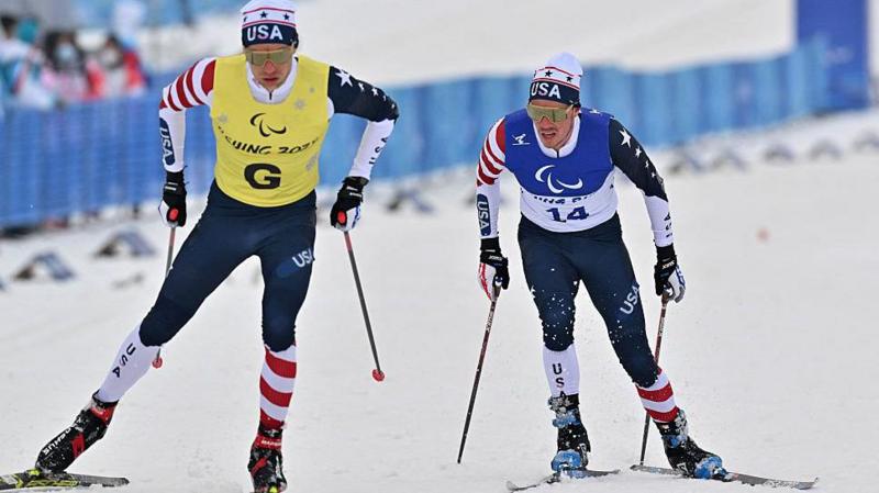 American cross-country skier Jake Adicoff follows his guide Sam Wood during the Beijing Paralympics