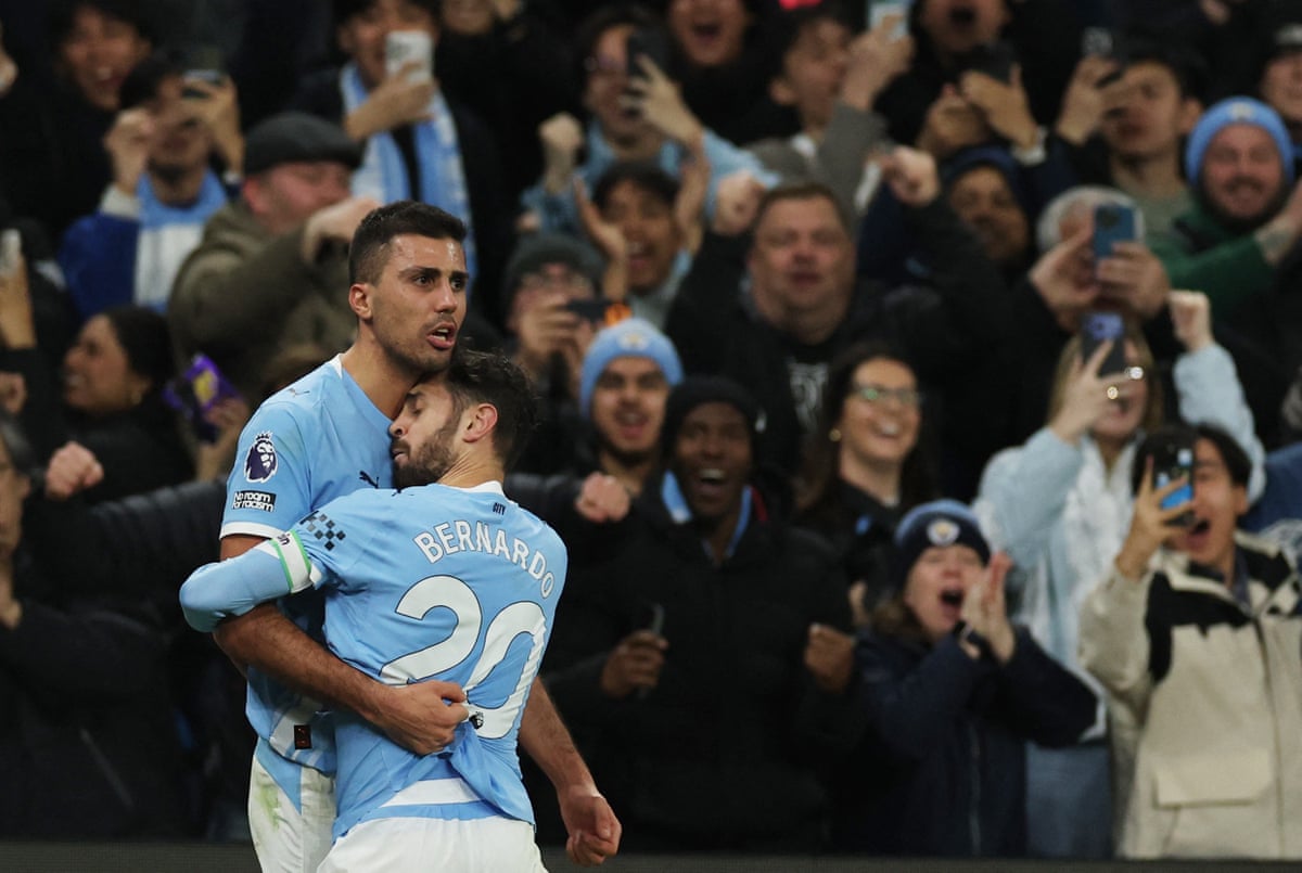 Rodri has a cuddle with Bernardo Silva.