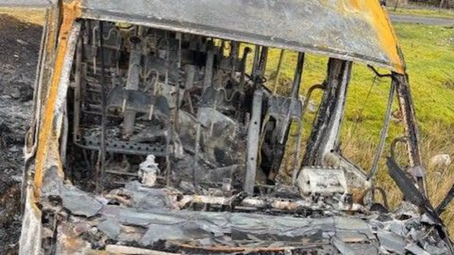 St Joseph's R.C. Primary School A view of the bus looking from the bonnet into the vehicle. There is no windscreen and the inside of the burnt out mini bus can be seen with the skeletal remains of the seats, and just some of the structure still in tact.