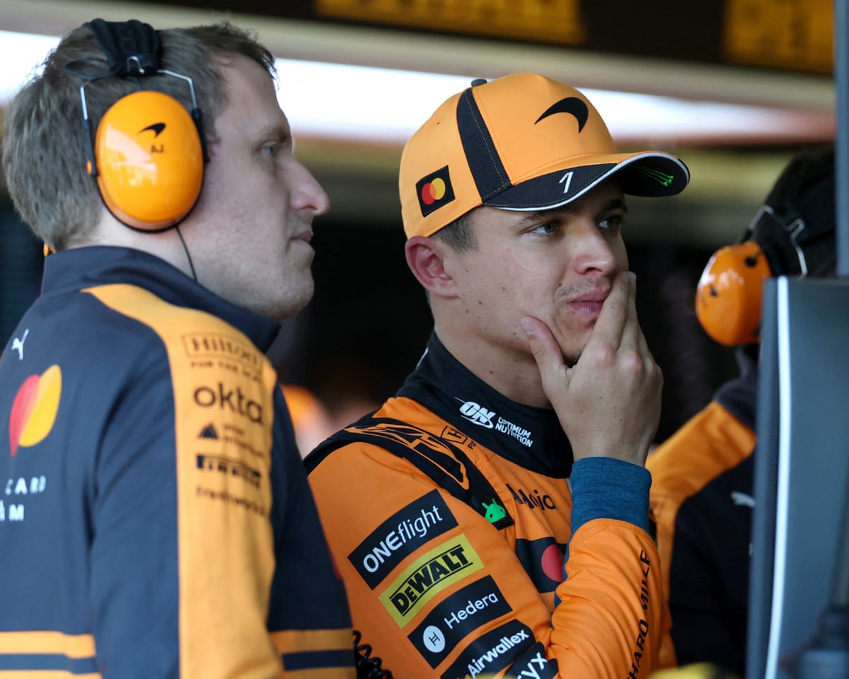 Lando Norris looks at a screen in the McLaren garage.