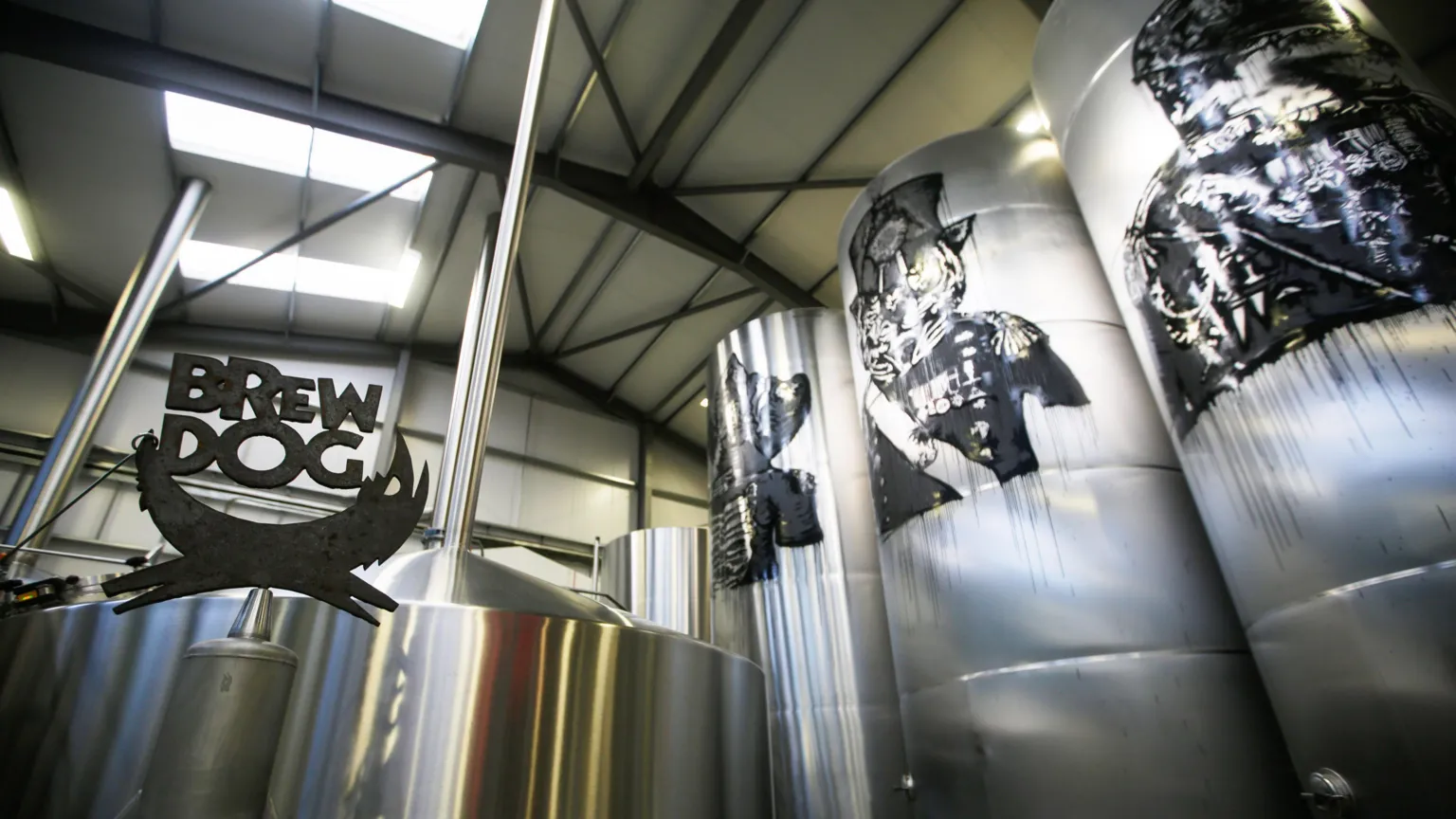  A metalwork sculpture of the Brewdog logo stands next to silver tanks inside the firm's brewery and headquarters in Aberdeenshire in 2015.